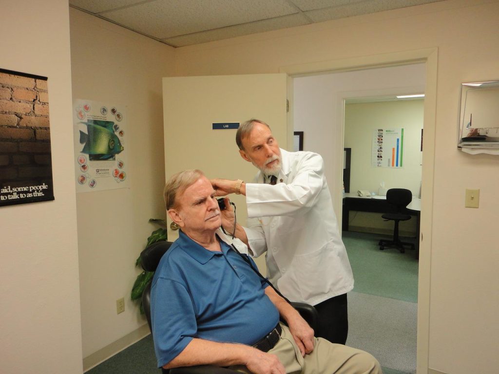 Audiologist conducting diagnostic test